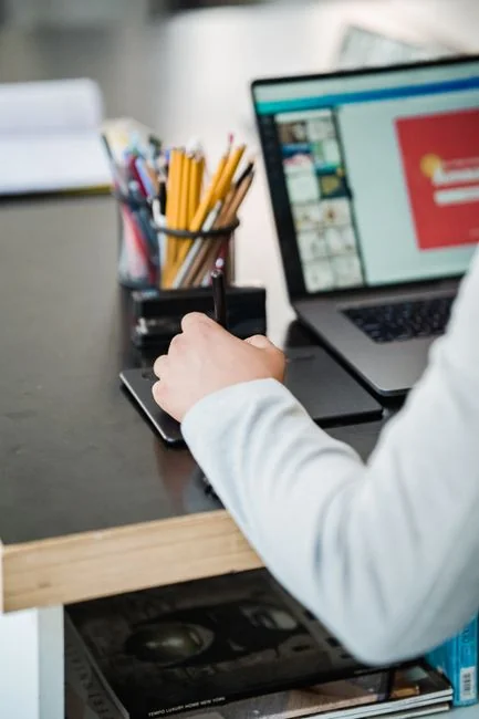 A person using a laptop to browse stock photo websites. Freelancing work in a cozy setting.